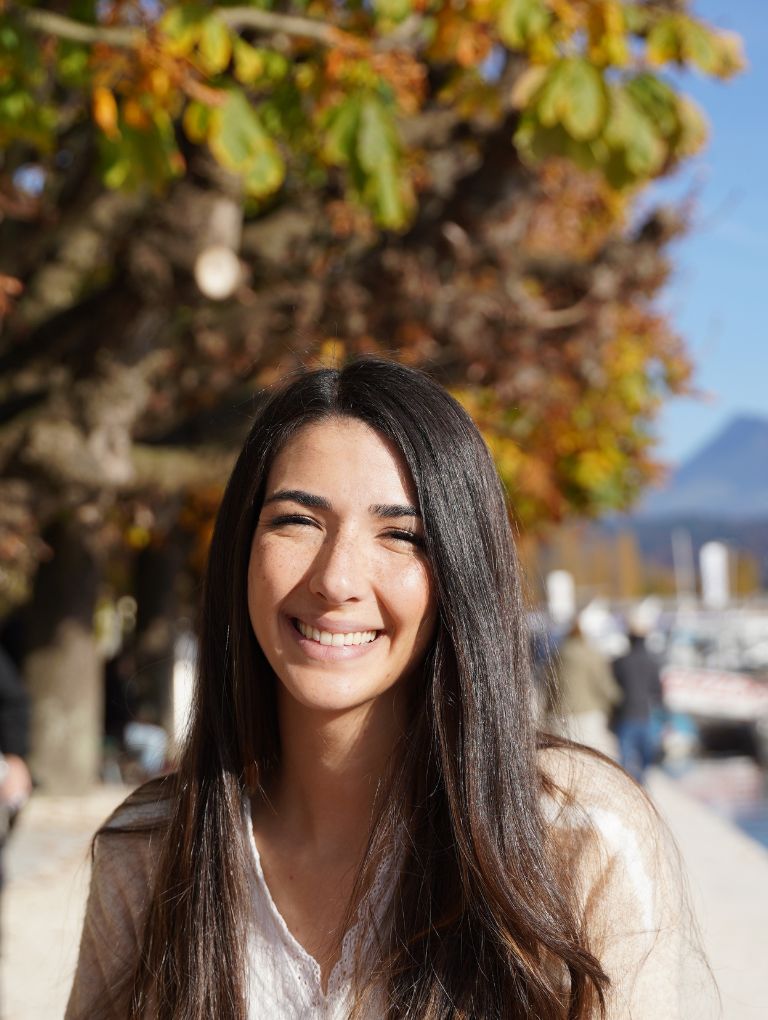 Smiling woman with fall leaves in background