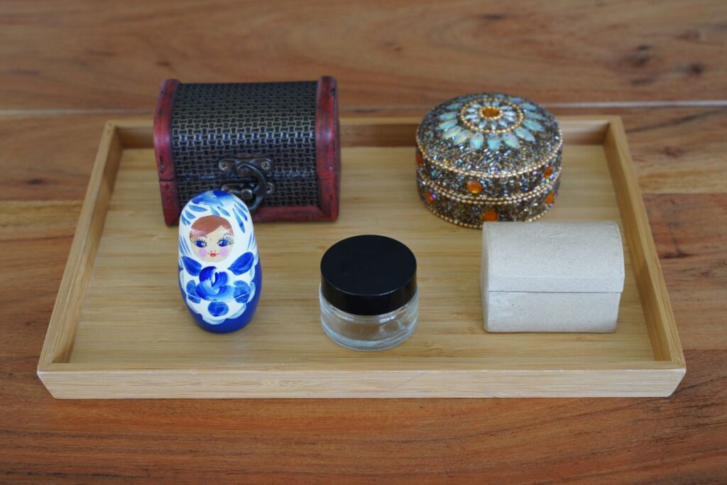 Montessori Practical Life activity tray with different boxes and containers for children to practice opening and closing to build fine motor skills and independence.