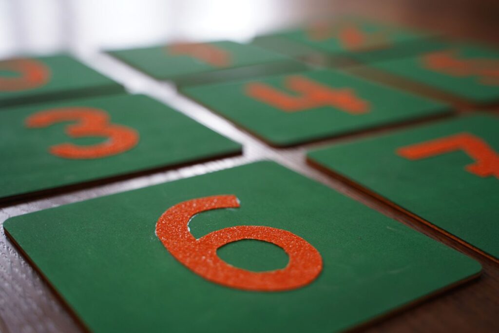 Montessori sandpaper numbers on green boards used for hands-on math learning.