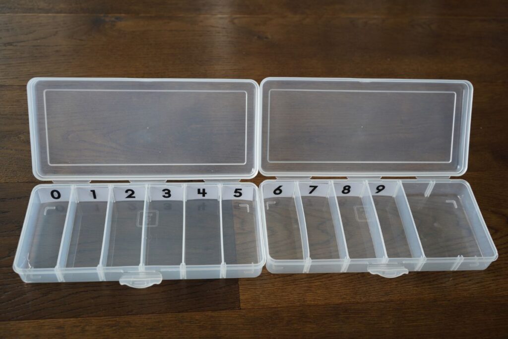 Completed Montessori DIY spindle box labeled 0–9 with compartments for counting, number recognition, and early math learning.