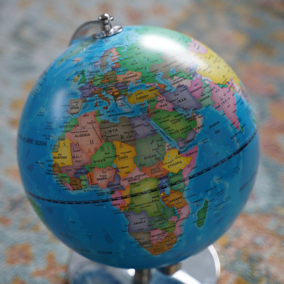 Close-up of a globe showing Europe, Africa, and parts of Asia with country names clearly labeled.