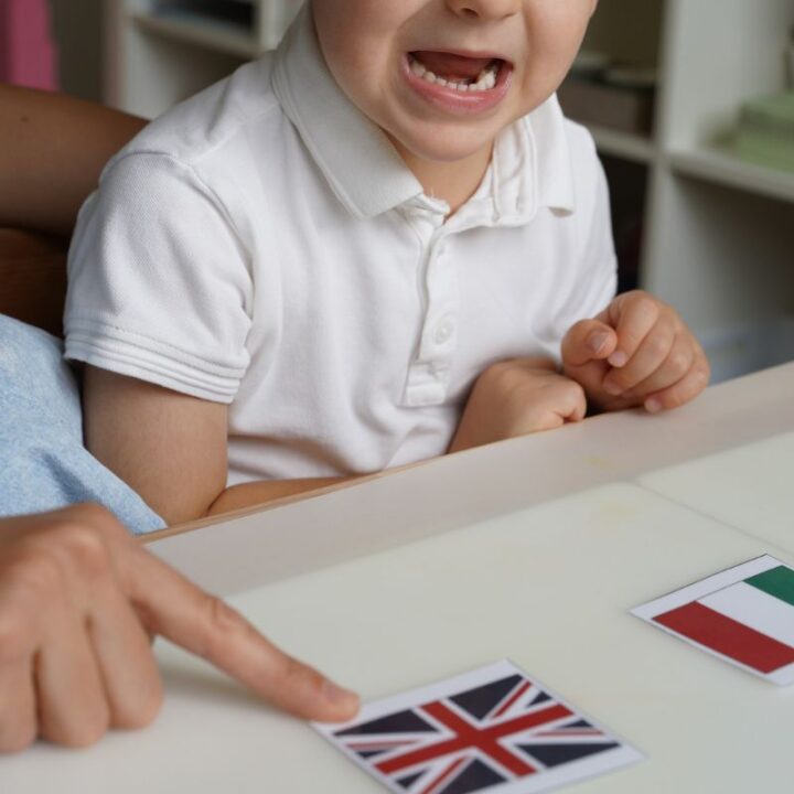 Montessori geography activity: child recalling and identifying the United Kingdom flag with Montessori flag cards.
